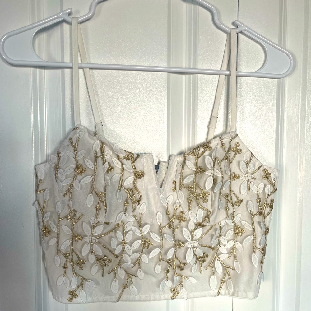 Women’s top. Cropped adjustable straps with back zipper. Size XS.